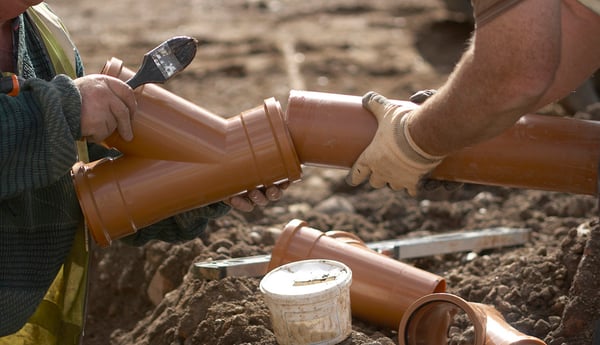 Builder-Laying-Sewage-Pipe-1