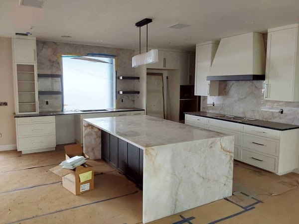 New-kitchen-under-construction-with-stone-counters-and-center-island-installed-1