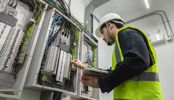 Electrical-engineer-working-front-control-panel-commercial-installation-1