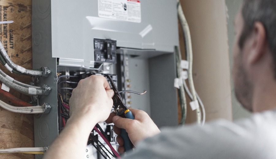 Electrician-upgrading-a-home-distribution-board Electrician-upgrading-a-home-distribution-board
