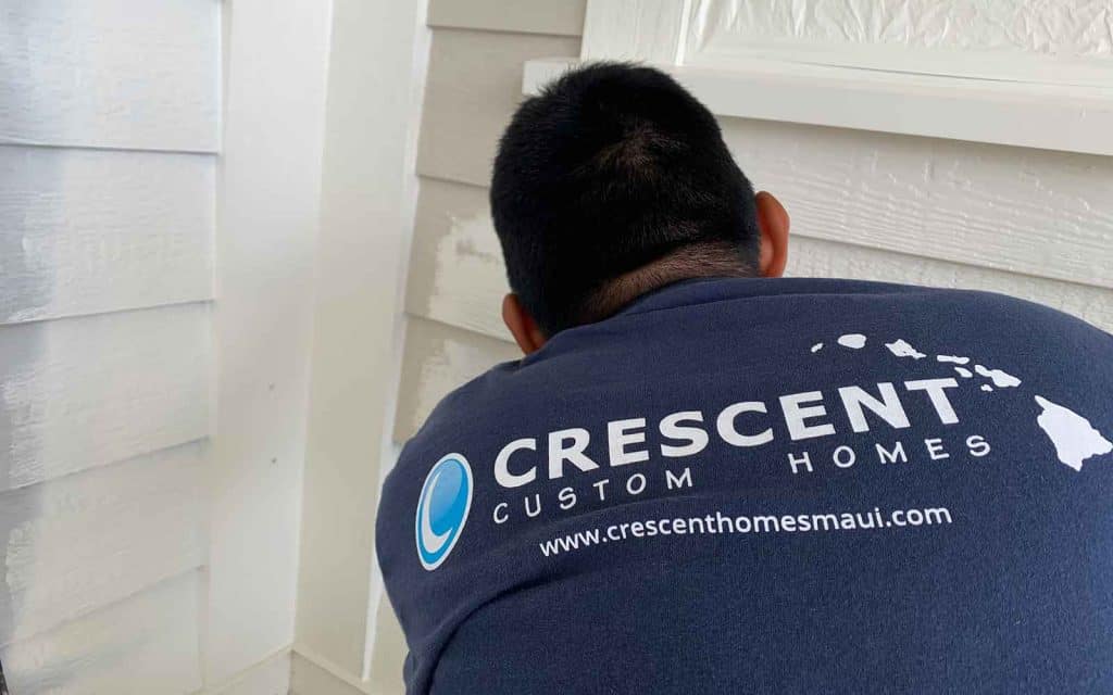 Painting and remodeling worker wearing Crescent Custom Homes t-shirt, Maui painting contractor