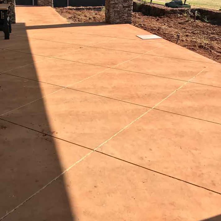 Image of a stamped concrete walkway in a pleasing brown and etched into sections.
