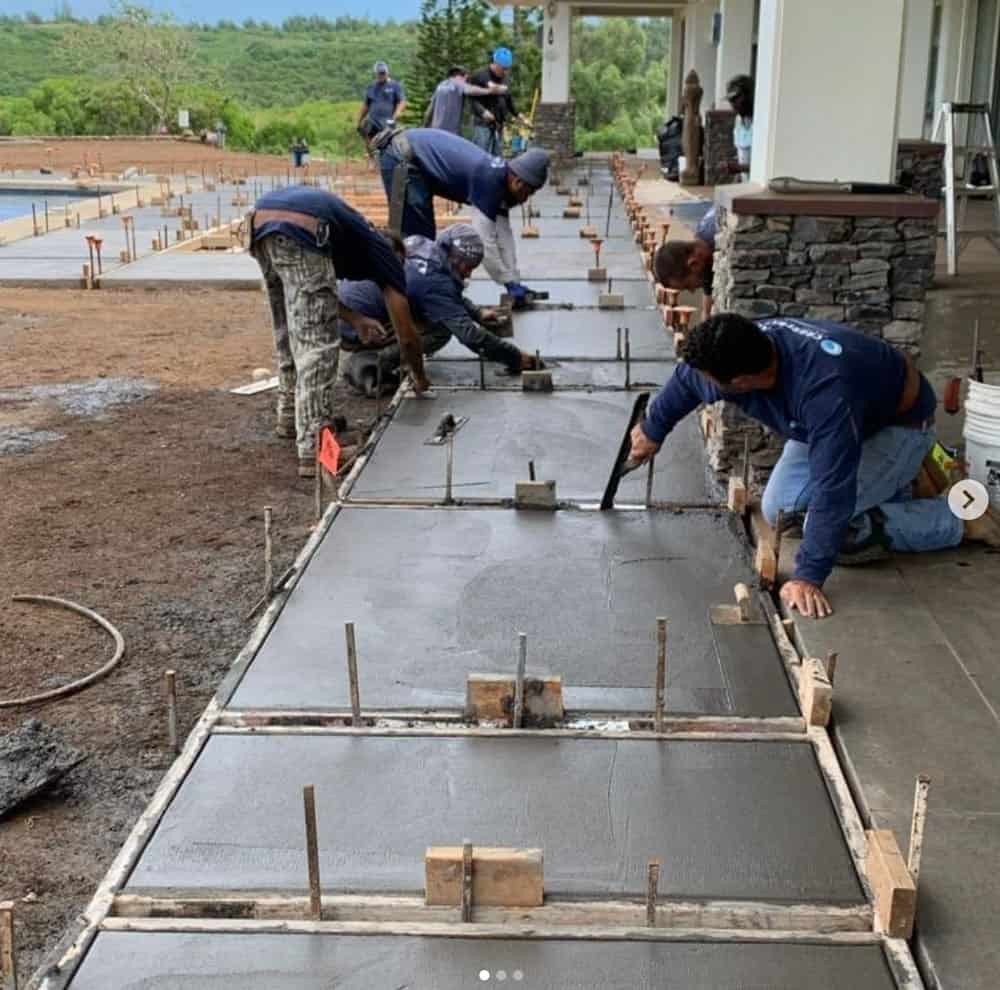 Crescent Homes Maui employees installing a new concrete walkway.
