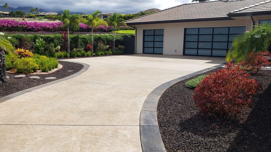 Image of stamped concrete driveway with concrete border, includes parking and garage