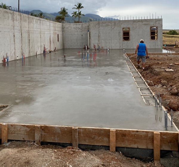 Image of recently poured concrete foundation that is now curing