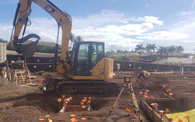 CAT Excavator preparing the site of a new Maui home as part of our general contractor services.
