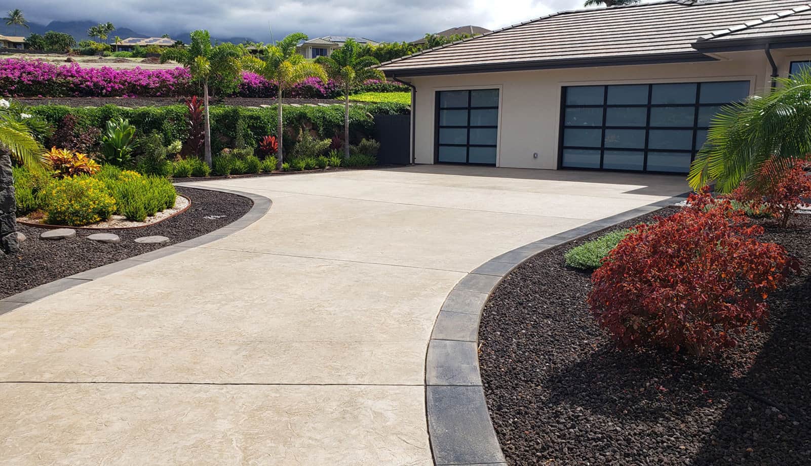 Stamped driveway with decorative edging designed and built by Crescent Homes Maui