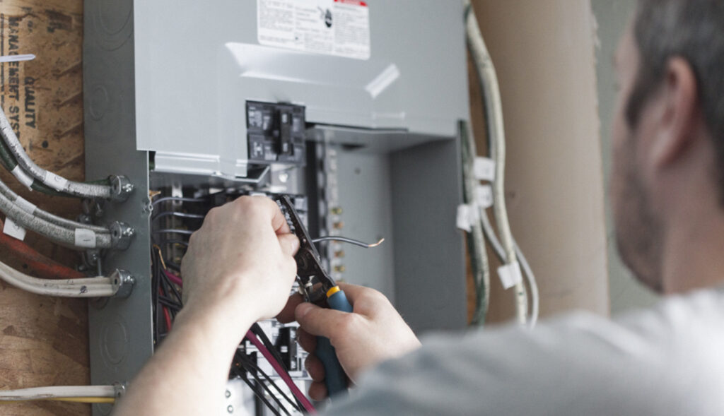 Electrician upgrading a home distribution board or electric box