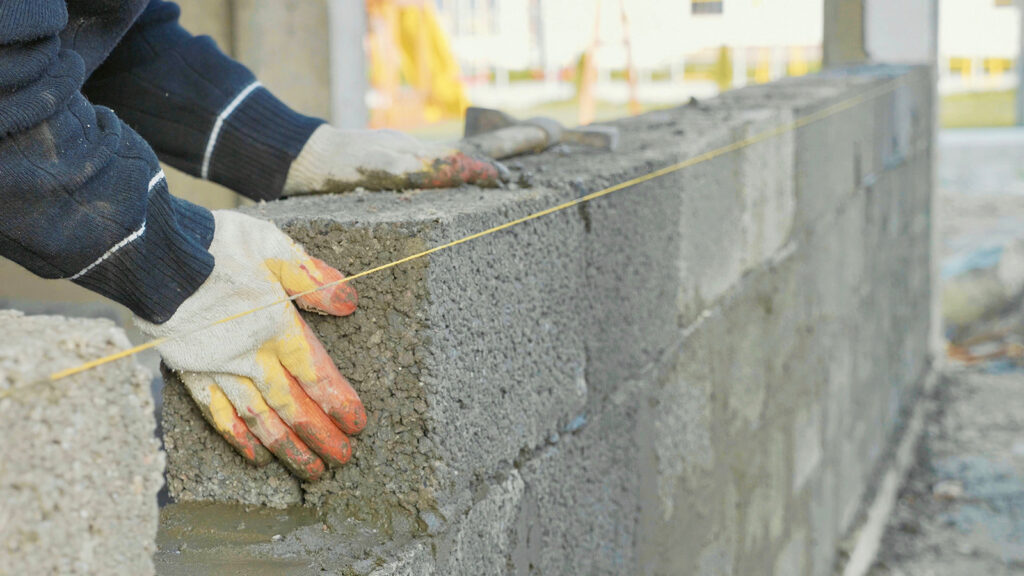 A concrete block wall under construction